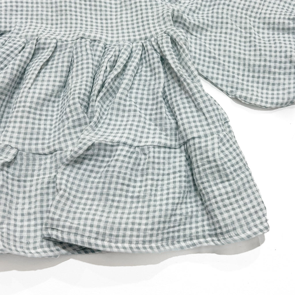 Our smock dress is a stunning piece that is perfect for twirling. Handmade with care in Australia. Made from a soft, lightweight, blue gingham muslin fabric, it feels comfortable against your child's skin.
The smock dress features a simple yet elegant design, with a classic round neckline, bell sleeves, and a flowing tiered skirt. The dress is available in a range of sizes to accommodate children of all ages, and its timeless design means it can be worn again and again for years to come.