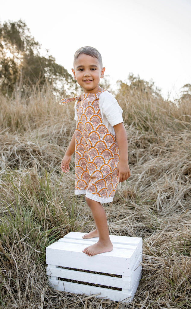 Handmade in Coffs Harbour, NSW, Australia, these muted orange, beige and white ‘sunrise’ overalls have been thoughtfully designed for growing children. Made with a gusset crutch for a comfy fit and adjustable tie shoulder straps for prolonged wear. 