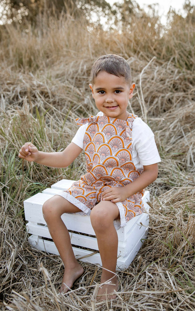 Handmade in Coffs Harbour, NSW, Australia, these muted orange, beige and white ‘sunrise’ overalls have been thoughtfully designed for growing children. Made with a gusset crutch for a comfy fit and adjustable tie shoulder straps for prolonged wear. 