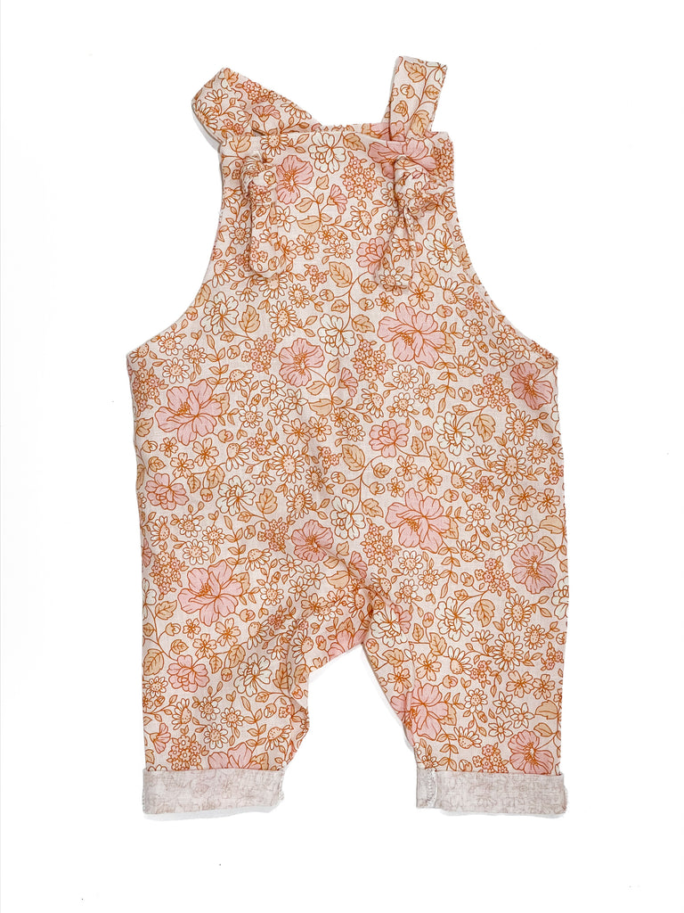 Handmade in Coffs Harbour, NSW, Australia, these peach, pink and sand ‘coral flora’ lined overalls have been thoughtfully designed for growing children. Made with a gusset crutch, extra length in the legs so they can be rolled for prolonged wear, and adjustable tie shoulder straps. 