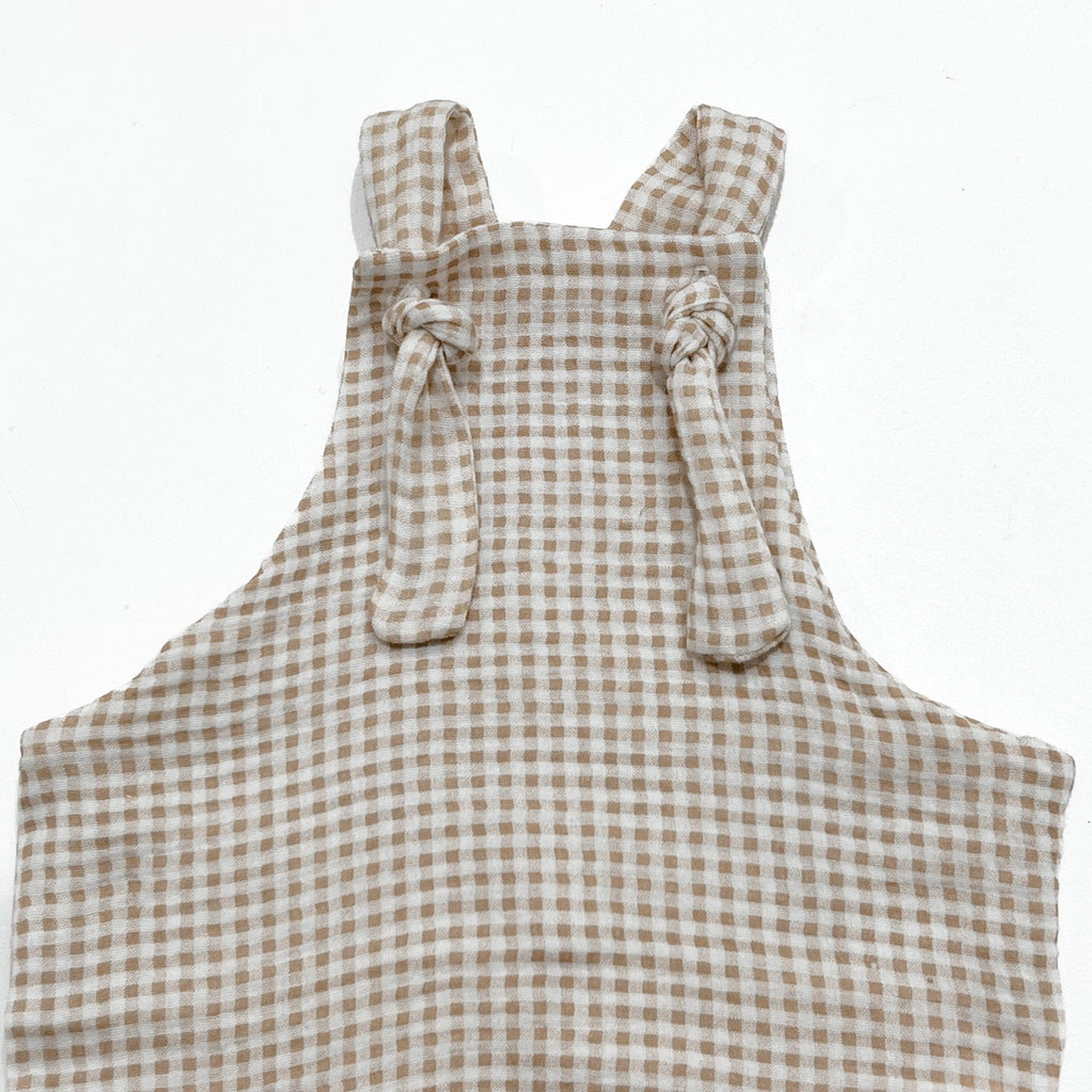 Handmade in Coffs Harbour, NSW, Australia, these beige and white gingham muslin overalls have been thoughtfully designed for growing children. Made with a gusset crutch, extra length in the legs so they can be rolled for prolonged wear, and adjustable tie shoulder straps. 