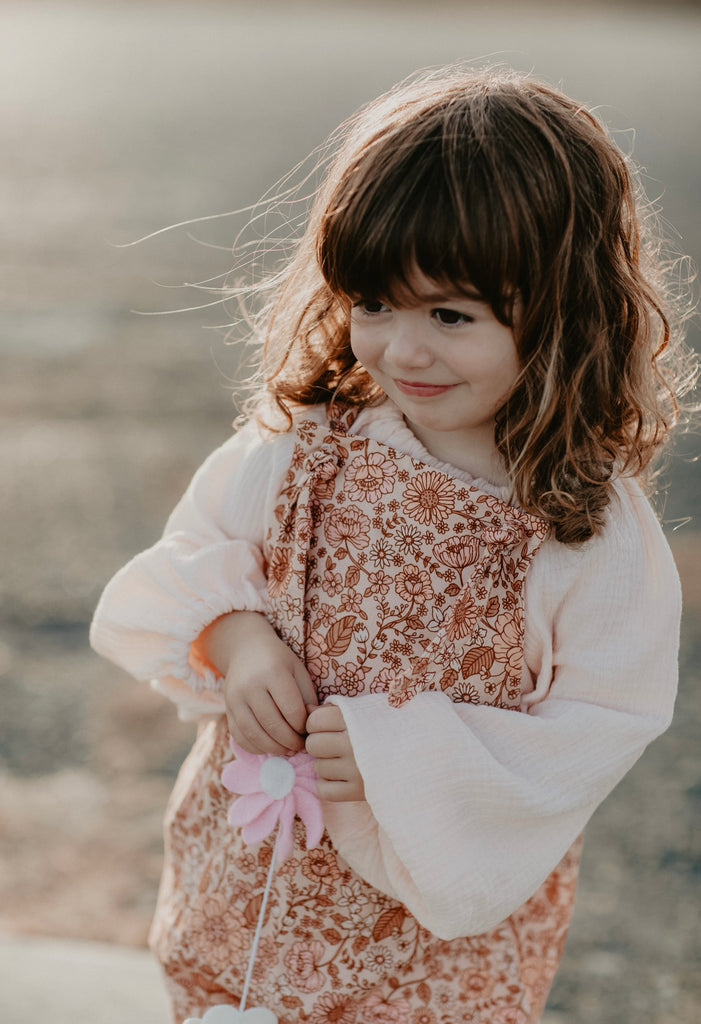 Handmade in Coffs Harbour, NSW, Australia, these muted pink, peach and tan ‘bloom’ print, linen overalls have been thoughtfully designed for growing children. Made with a gusset crutch for a comfy fit, extra length on the hems for rolling and adjustable tie shoulder straps, all for prolonged wear. 