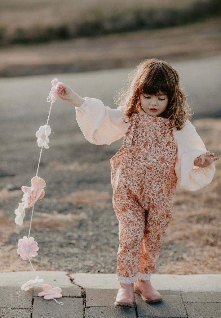Handmade in Coffs Harbour, NSW, Australia, these muted pink, peach and tan ‘bloom’ print, linen overalls have been thoughtfully designed for growing children. Made with a gusset crutch for a comfy fit, extra length on the hems for rolling and adjustable tie shoulder straps, all for prolonged wear. 