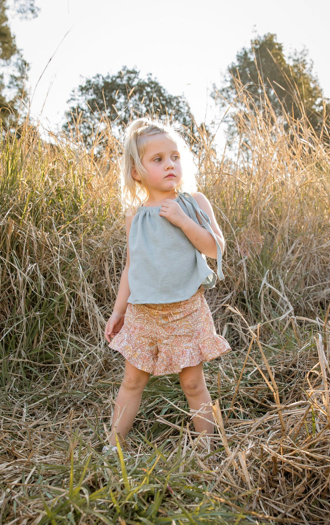 Our handmade in Australia, Frill Shorts are made with a soft natural linen that will just get better with wear and age. They have elastic waists to assist those parents who have to wrangle a wriggle worm just to get them dressed. In our ‘Paisley’ featuring a combination of sea glass blues, pinks, light tan and oat, these frill hem shorts are the perfect combination of cute and functional.
