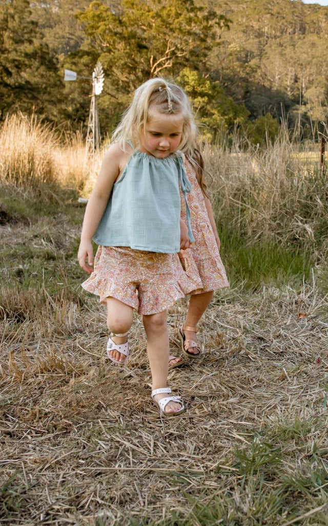Made for fun and perfect for both dressy and casual occasions. 

Handmade in Coffs Harbour, NSW, these tie-top swing tops have been thoughtfully designed for growing children, with a fully adjustable neckline.

Our handmade swing tie tops are made with a soft muted blue-green ‘sea glass’ muslin that will just get better with wear and age.