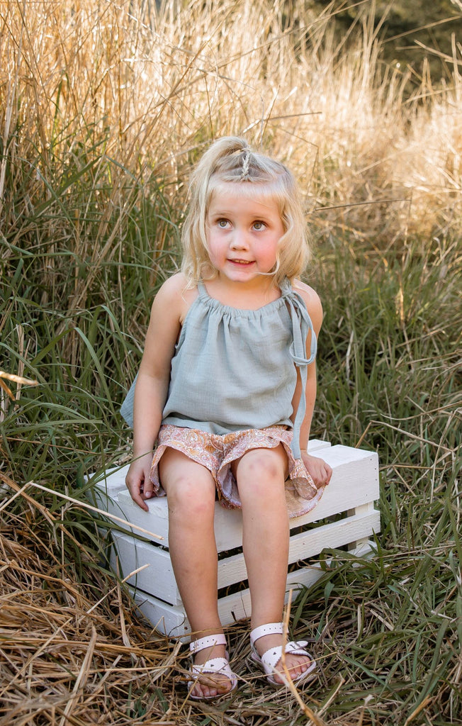 Made for fun and perfect for both dressy and casual occasions. 

Handmade in Coffs Harbour, NSW, these tie-top swing tops have been thoughtfully designed for growing children, with a fully adjustable neckline.

Our handmade swing tie tops are made with a soft muted blue-green ‘sea glass’ muslin that will just get better with wear and age.