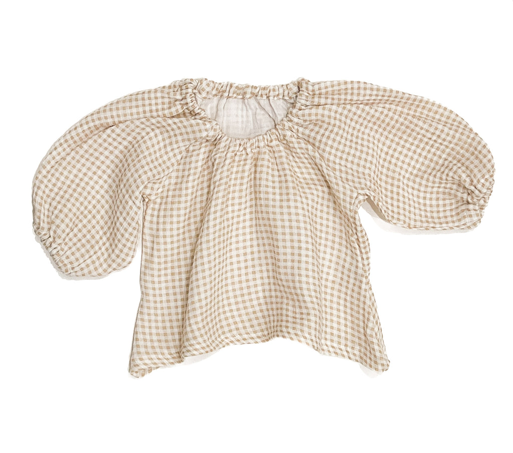 Our handmade smock tops are made with a soft beige oat and white gingham cotton muslin that will just get better with wear age. With a handkerchief hem and elastic cuff bell sleeves, it’s perfect layered under our overalls or paired with our harems, bloomers, frill shorts.