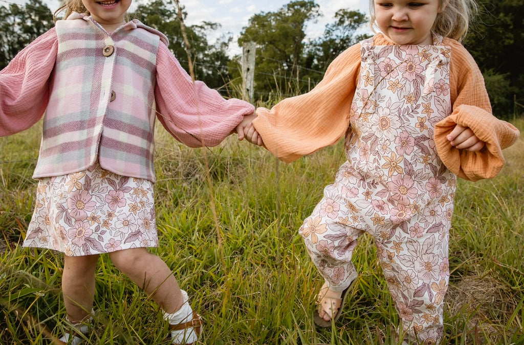 Our handmade smock tops are made with a soft muted papaya orange cotton muslin that will just get better with wear age. With a handkerchief hem and elastic cuff bell sleeves, it’s perfect layered under our overalls or paired with our harems, bloomers, frill shorts.