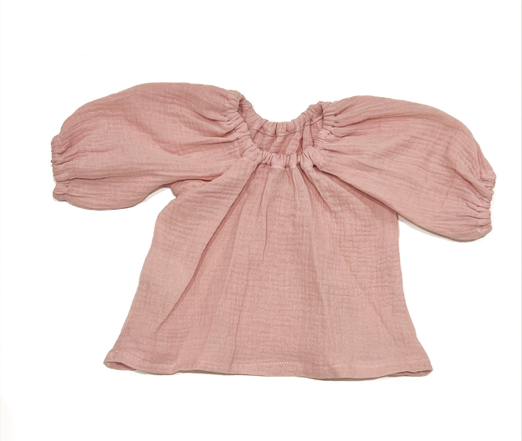 Our handmade smock tops are made with a soft muted primrose pink cotton muslin that will just get better with wear age. With a handkerchief hem and elastic cuff bell sleeves, it’s perfect layered under our overalls or paired with our harems, bloomers, frill shorts.